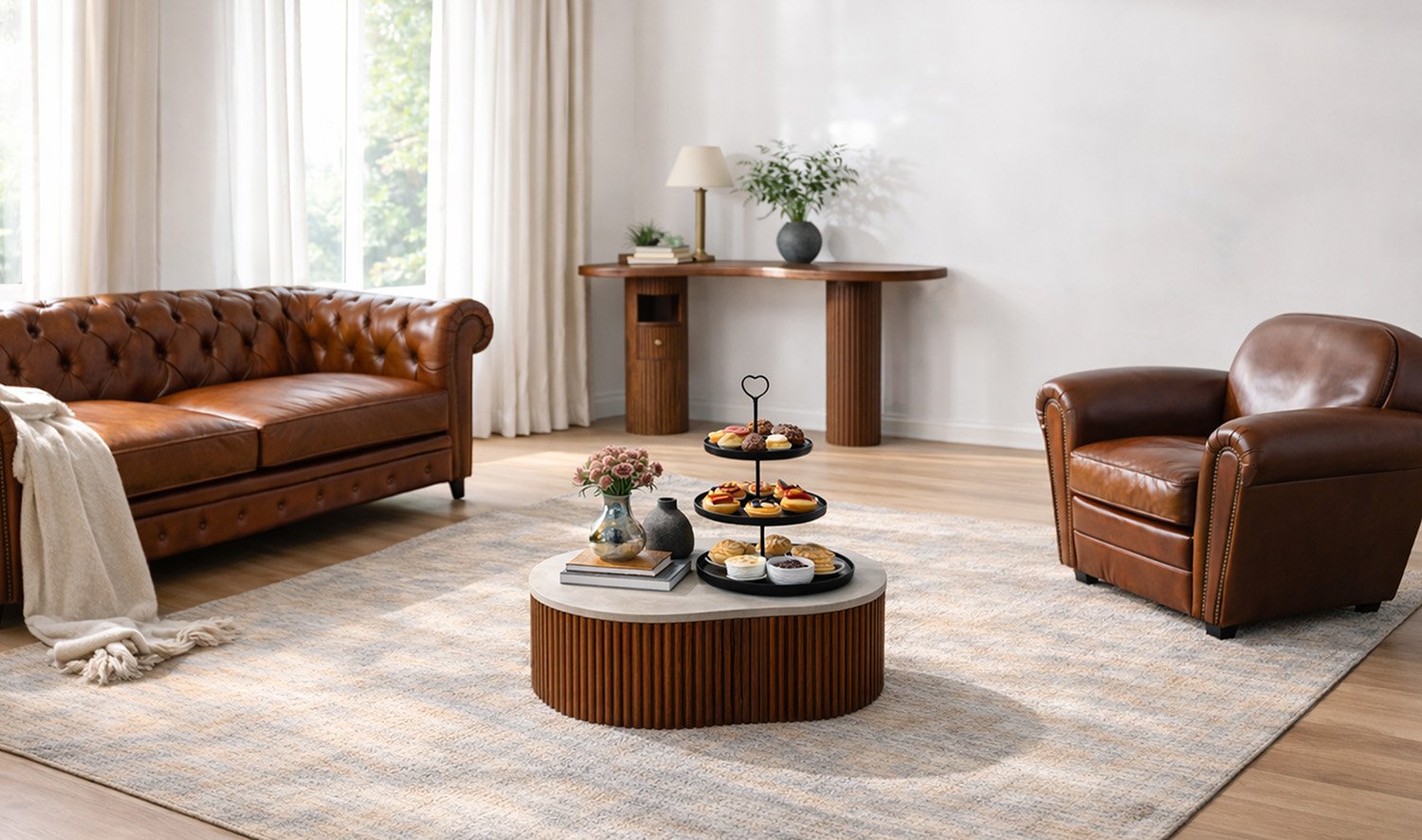 Brown leather Chesterfield sofa and matching armchair in a bright living room with a round wooden coffee table and rug.